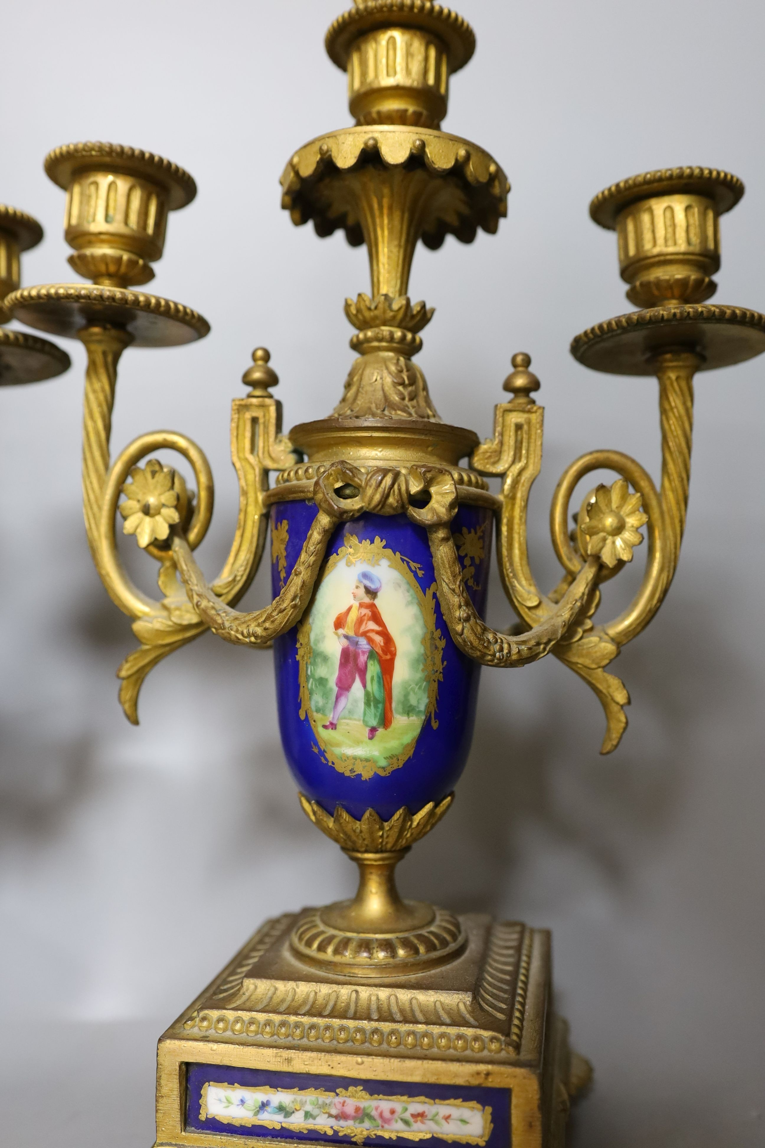 A pair of Sevres style porcelain and ormolu candelabra, 36 cms high.